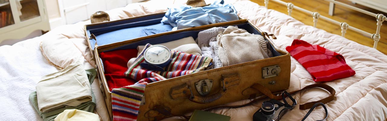 Items in suitcase on bed.